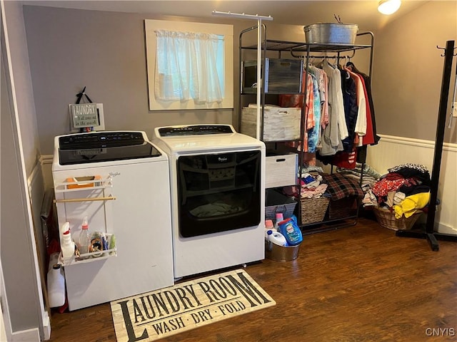 clothes washing area with washer and dryer, laundry area, and wood finished floors