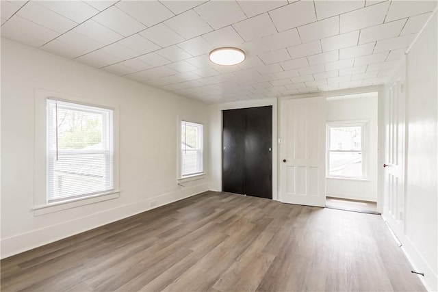 interior space featuring baseboards and wood finished floors