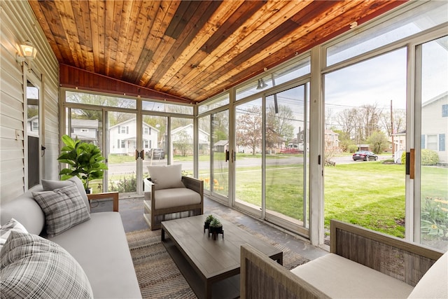 sunroom / solarium featuring a wealth of natural light and a residential view