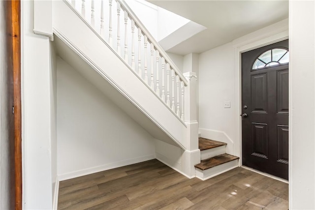 entrance foyer featuring stairway, wood finished floors, and baseboards