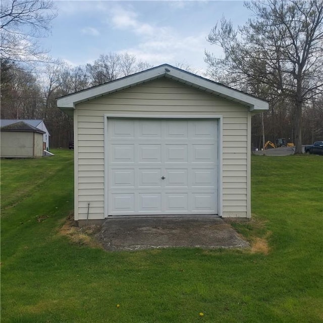 detached garage featuring driveway