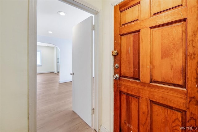 321 Eggert Rd, Cheektowaga, NY 14215 - hall with arched walkways, light wood-style flooring, baseboards, and recessed lighting
