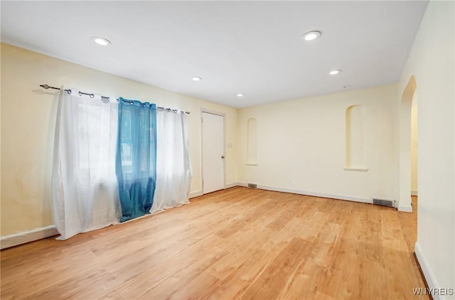 321 Eggert Rd, Cheektowaga, NY 14215 - empty room featuring wood finished floors, arched walkways, baseboards, and recessed lighting