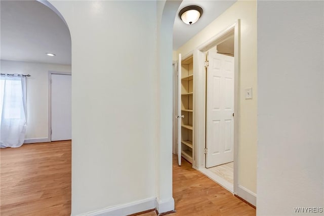 321 Eggert Rd, Cheektowaga, NY 14215 - corridor featuring arched walkways, light wood finished floors, baseboards, and recessed lighting