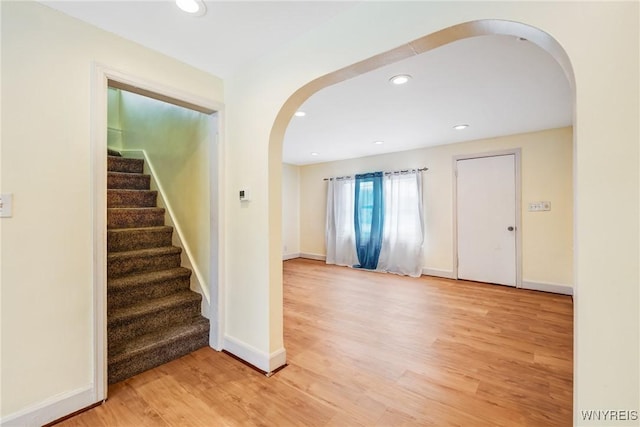 321 Eggert Rd, Cheektowaga, NY 14215 - staircase featuring arched walkways, wood finished floors, recessed lighting, and baseboards