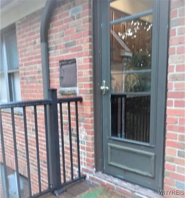 entrance to property with brick siding