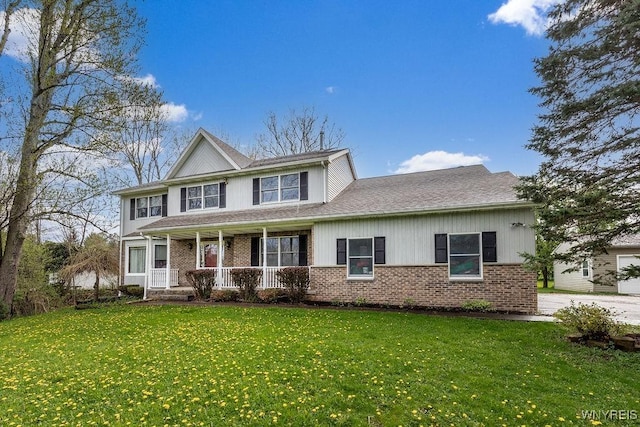 traditional-style home with a porch, brick siding, and a front lawn