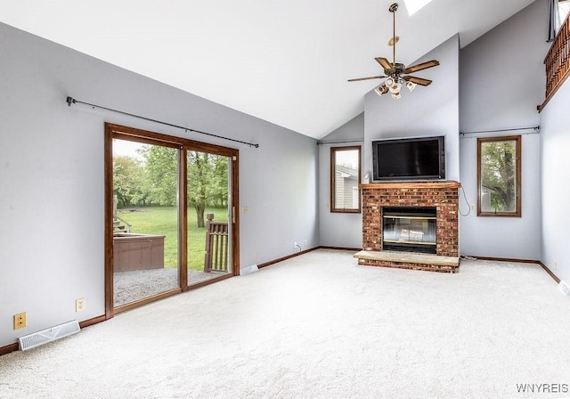 unfurnished living room with carpet floors, a brick fireplace, baseboards, and high vaulted ceiling