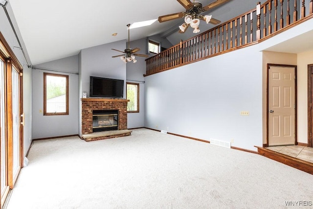 unfurnished living room featuring ceiling fan, carpet flooring, high vaulted ceiling, and baseboards