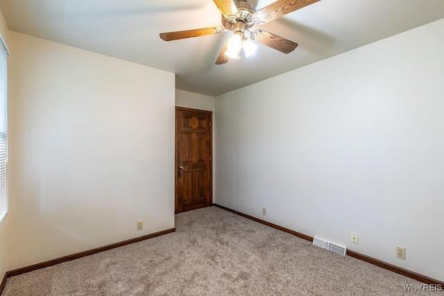 empty room featuring carpet, baseboards, and ceiling fan