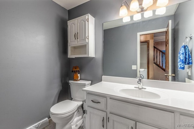 half bathroom featuring toilet and vanity
