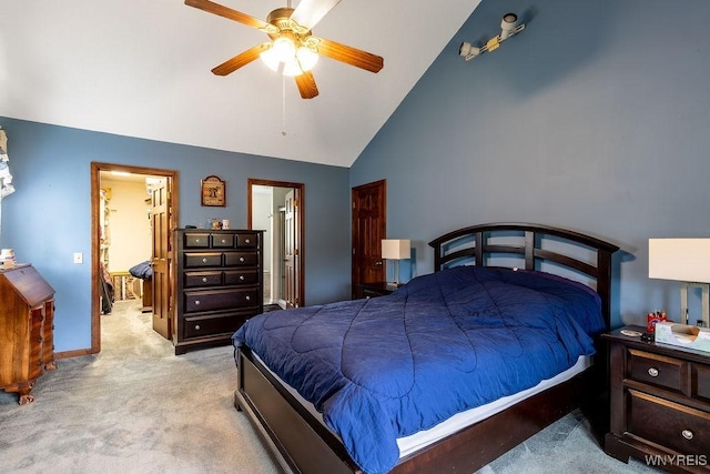 carpeted bedroom with high vaulted ceiling, ceiling fan, baseboards, and ensuite bathroom