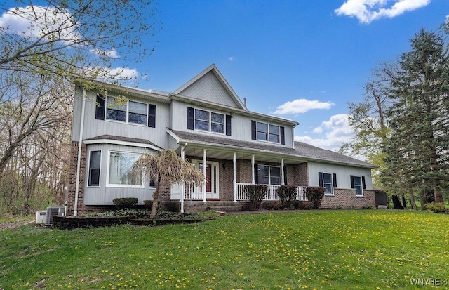 view of front of home with a porch, a front lawn, brick siding, and central AC unit