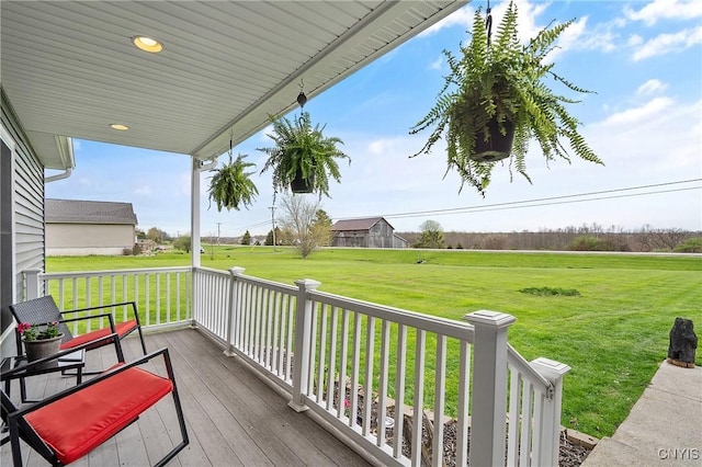 26519 State Route 180, Brownville, NY 13634 - wooden deck with covered porch and a lawn
