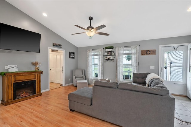 26519 State Route 180, Brownville, NY 13634 - living area with baseboards, lofted ceiling, a ceiling fan, and a glass covered fireplace