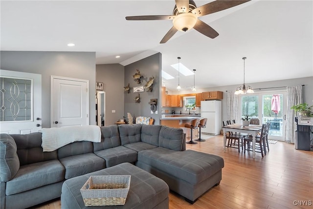 26519 State Route 180, Brownville, NY 13634 - living room with recessed lighting, high vaulted ceiling, light wood-type flooring, and ceiling fan with notable chandelier