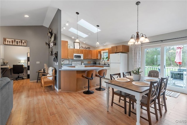26519 State Route 180, Brownville, NY 13634 - dining area featuring a wealth of natural light, a chandelier, light wood-type flooring, and a skylight