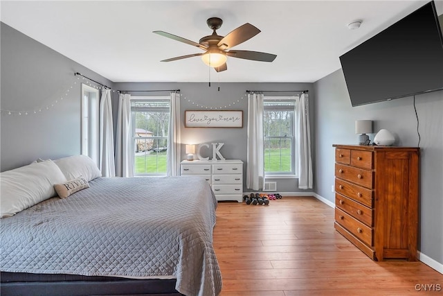 26519 State Route 180, Brownville, NY 13634 - bedroom featuring multiple windows, light wood-style floors, baseboards, and a ceiling fan