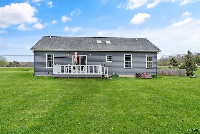 26519 State Route 180, Brownville, NY 13634 - rear view of house featuring a yard, a deck, a shingled roof, and fence