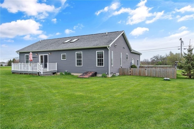 26519 State Route 180, Brownville, NY 13634 - rear view of house with roof with shingles, a deck, fence, and a lawn