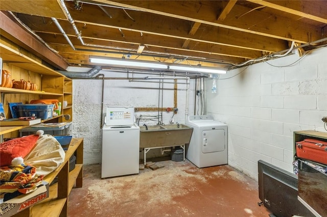 unfinished below grade area featuring washer and dryer and a sink