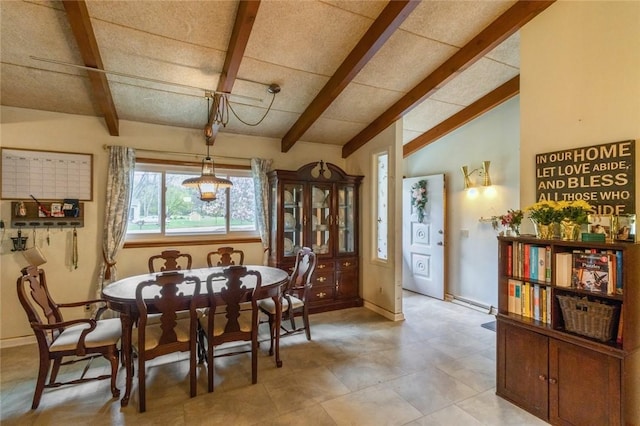 dining room with baseboard heating, baseboards, and lofted ceiling with beams