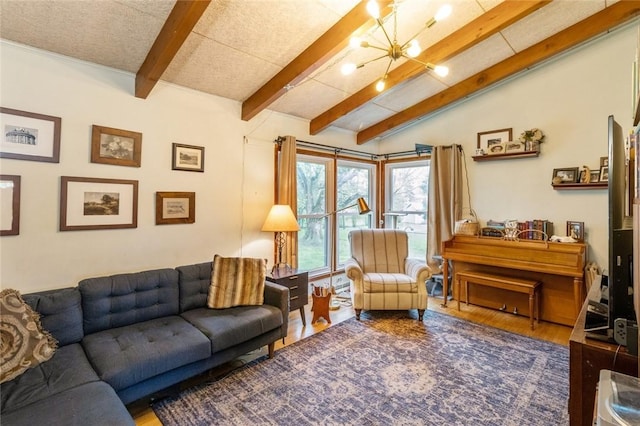 living area with lofted ceiling with beams and wood finished floors