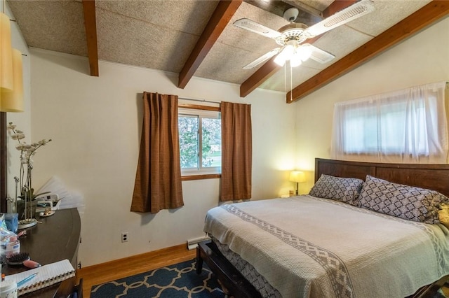 bedroom with lofted ceiling with beams, a ceiling fan, visible vents, and wood finished floors