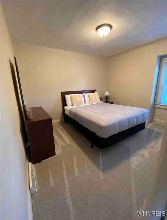 carpeted bedroom with baseboards