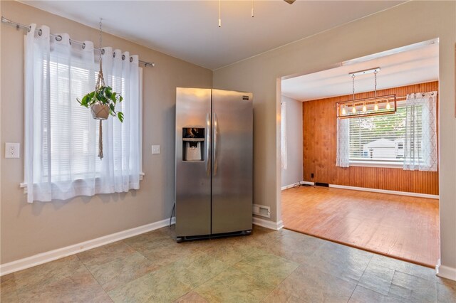 kitchen with stainless steel fridge with ice dispenser and baseboards