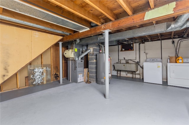 unfinished below grade area with heating unit, water heater, washing machine and dryer, and a sink