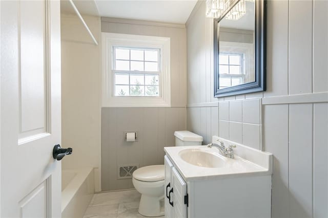 bathroom with toilet, visible vents, a decorative wall, marble finish floor, and vanity