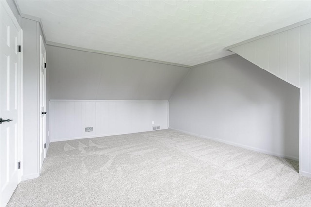 bonus room with vaulted ceiling, carpet, baseboards, and visible vents