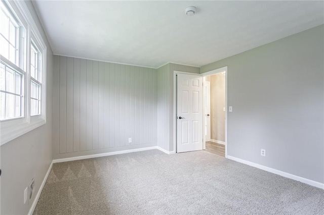 carpeted empty room with visible vents and baseboards