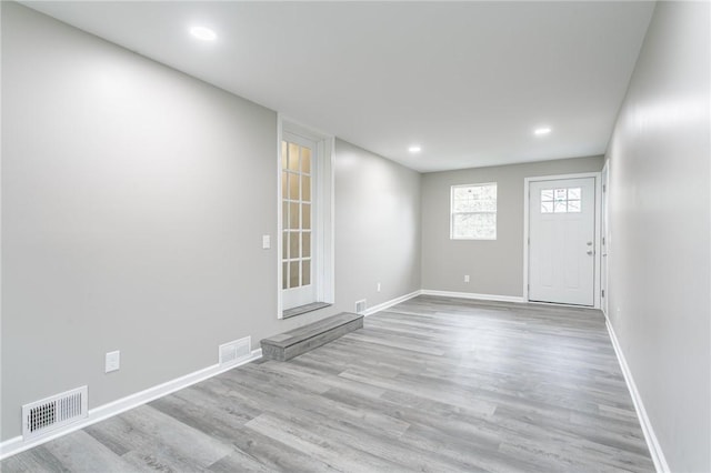 interior space featuring baseboards, recessed lighting, visible vents, and wood finished floors