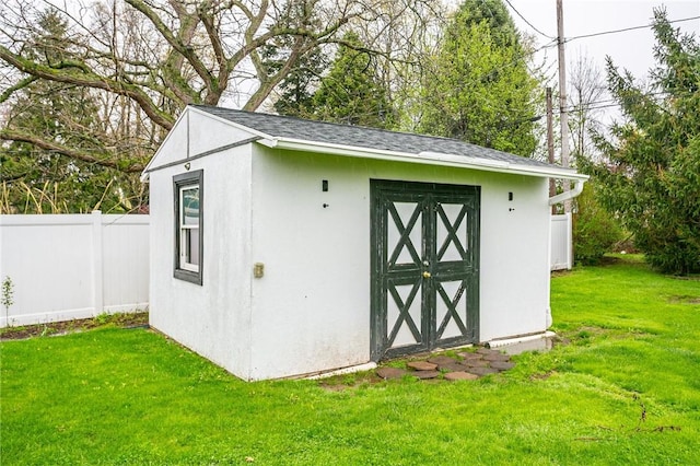 view of shed featuring fence