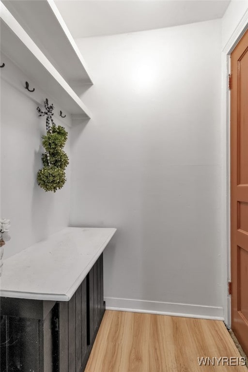 mudroom with light wood finished floors and baseboards