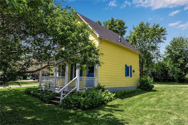 view of property exterior with covered porch, a lawn, and roof with shingles