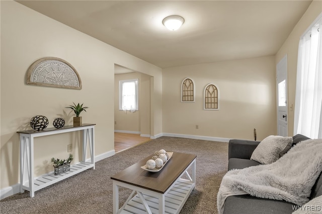 living room featuring carpet flooring and baseboards