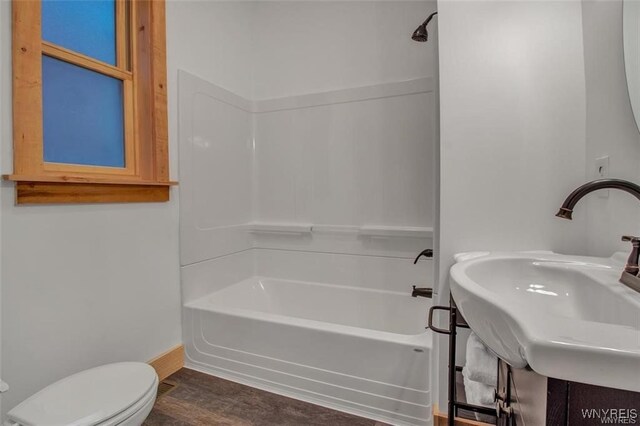 58 Park St, Buffalo, NY 14201 - bathroom featuring bathtub / shower combination, toilet, baseboards, and wood finished floors