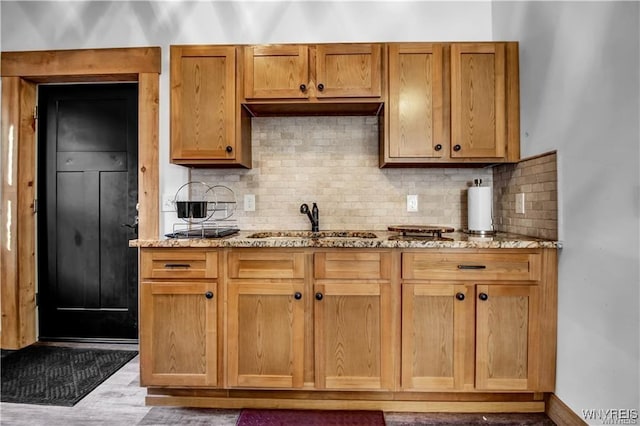 58 Park St, Buffalo, NY 14201 - kitchen with a sink, light stone countertops, tasteful backsplash, and wood finished floors