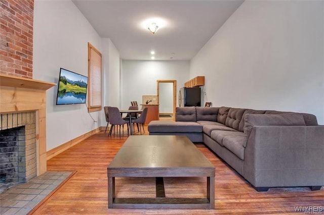 58 Park St, Buffalo, NY 14201 - living area featuring wood finished floors, a fireplace, and baseboards