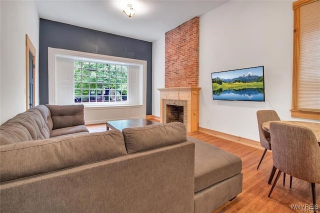 58 Park St, Buffalo, NY 14201 - living area featuring wood finished floors, a fireplace, and baseboards
