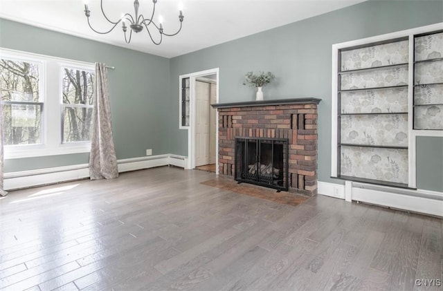 83 Salisbury St, Sandy Creek, NY 13083 - unfurnished living room with wood finished floors, a fireplace, an inviting chandelier, baseboard heating, and baseboards