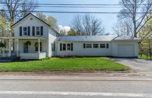 83 Salisbury St, Sandy Creek, NY 13083 - traditional-style home with metal roof, a garage, a porch, and driveway