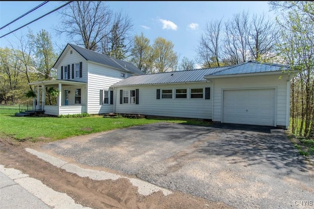83 Salisbury St, Sandy Creek, NY 13083 - view of front of home with an attached garage, a front yard, metal roof, and aphalt driveway