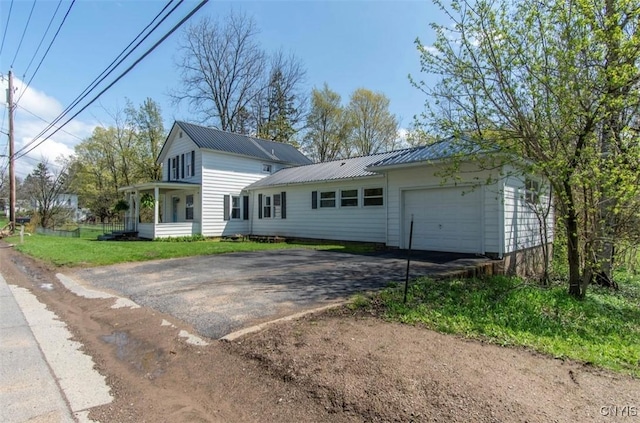 83 Salisbury St, Sandy Creek, NY 13083 - exterior space featuring metal roof, a lawn, an attached garage, and driveway