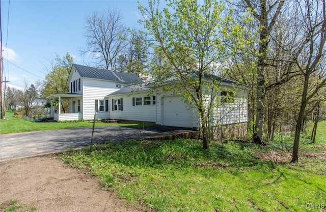 83 Salisbury St, Sandy Creek, NY 13083 - view of property exterior with metal roof, a yard, driveway, and a garage