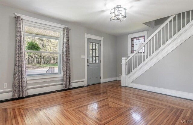 83 Salisbury St, Sandy Creek, NY 13083 - entrance foyer with stairway, baseboards, and a notable chandelier
