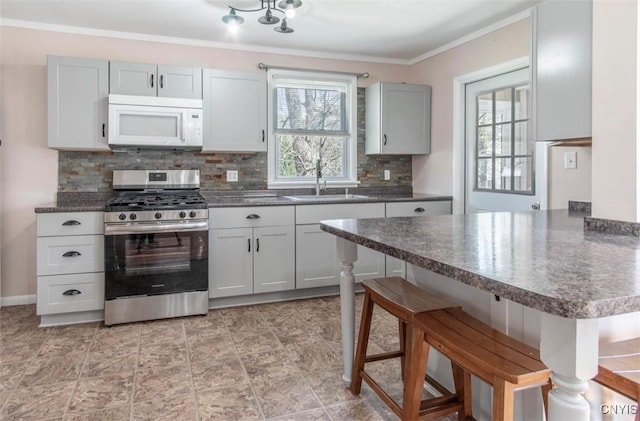 83 Salisbury St, Sandy Creek, NY 13083 - kitchen with a sink, white microwave, a kitchen bar, plenty of natural light, and stainless steel gas range